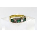 An emerald and diamond five stone half eternity ri