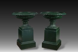 A pair of green patinated cast iron garden vases on stand, 20th C.