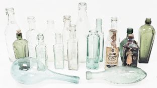 A collection of green tinted bottles, apothecary jars and other items including a partially boxed