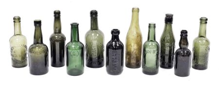 A collection of green tinted bottles including examples named Slack & Cox Limited Manchester,