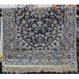 Persian-style midnight blue ground rug with central floral motif, floral spandrels, multiple