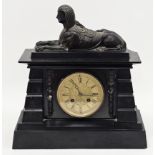 Victorian Egyptian Revival black slate mantle clock, the case of architectural form and surmounted