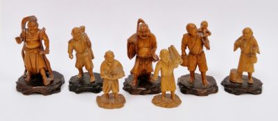 Seven Japanese carved boxwood figures including two figures of Gods, a group of smaller figures of