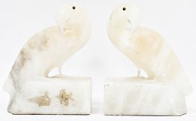 Pair of Art Deco pink tinted alabaster bookends in the form of parakeets, 15cm high