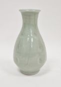 Jim Malone (1946-), a porcelain celadon glazed bottle vase, incised with panels enclosing