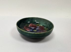 Moorcroft green-ground Clematis pattern small circular dish, impressed marks, 11.5 cm diam.