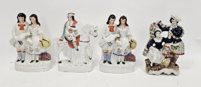 Group of four late 19th century Staffordshire pottery figures and groups, comprising: a pair
