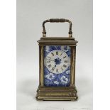 Late 19th century porcelain panelled brass cased carriage clock, the blue and white panels with