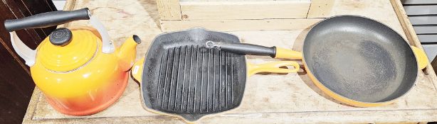 Collection of Le Creuset kitchen wares, including: two two-handled cast iron casserole dishes and