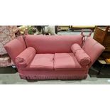 Knole-type sofa upholstered in a pink fabric with lattice design, two drop ends, two seat cushions