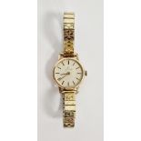 Lady's Garrard 9ct gold bracelet watch, the circular dial with baton markers, on gilt metal