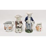 Two Staffordshire pearlware toby jugs, early 19th century, the first modelled seated on a case