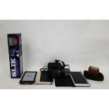 Kindle 4th generation model D01100 together with a collection of cameras and equipment including