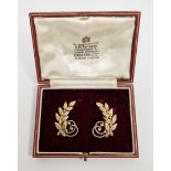 Pair of 9ct gold clip-on earrings, each modelled as a curving spray of leaves with scrolling