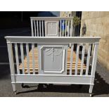 Early 20th century double bedstead, the slatted headboard and footboard later painted white, on a