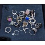 Twenty silver, silver-gilt and white metal dress rings mounted with assorted coloured stones, some