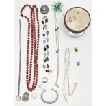 Simulated pearls, a green and white diamante bangle, silver ARP badge, silver ring, silver curb link
