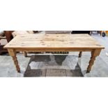 Pine kitchen or dining table, the three plank top on turned baluster legs, 77cm high x 213cm long