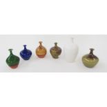 Six studio pottery bottle vases by Russell Akerman, comprising a oviform white glazed example, 16.