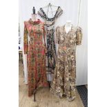 A cotton 1970's maxi dress, bold pattern in black, green, pink with flowers etc., elasticated