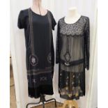 Black 1920's beaded dress with fringed hem, cap sleeves, a beaded band around the hem (a little