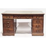 Early 20th-century oak twin-pedestal writing desk, the rectangular top with green leather inset