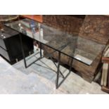 Contemporary console table, the glass top on a black metal tubular frame, 71cm high x 140cm wide x