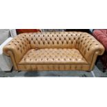 Chesterfield sofa upholstered in tan brown buttoned and studded upholstery, on squat bun wooden feet