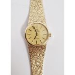 Lady's 9ct gold Omega De Ville wristwatch, the champagne coloured dial with raised baton hour
