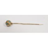 Late 19th / early 20th-century yellow metal stick pin, the ball finial with foliate scroll engraving
