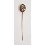Antique gold coloured metal portrait stickpin, the oval head set with a miniature painted