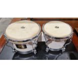 Pair of Meinl bongo drums, each with buffalo skin heads and white plastic and chrome-plated