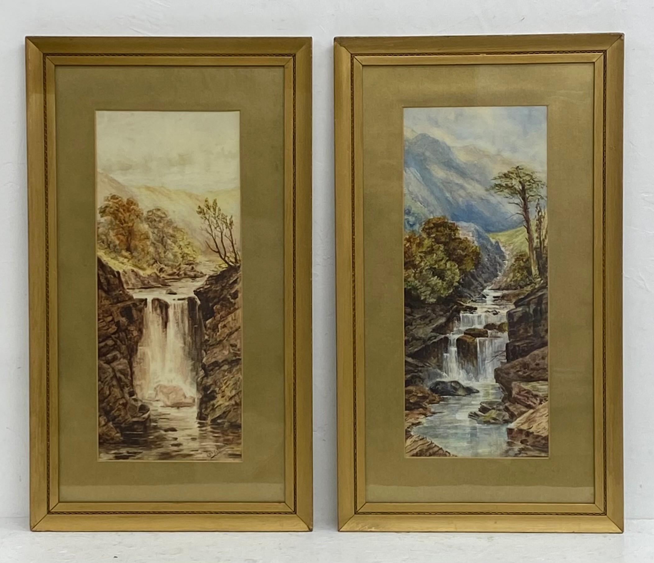 A pair of 19th century watercolour paintings depicting waterfalls in country landscapes by Lucy