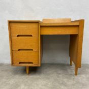 A mid-century Stag 'C' range oak dressing table with black laminate top enclosing mirror and
