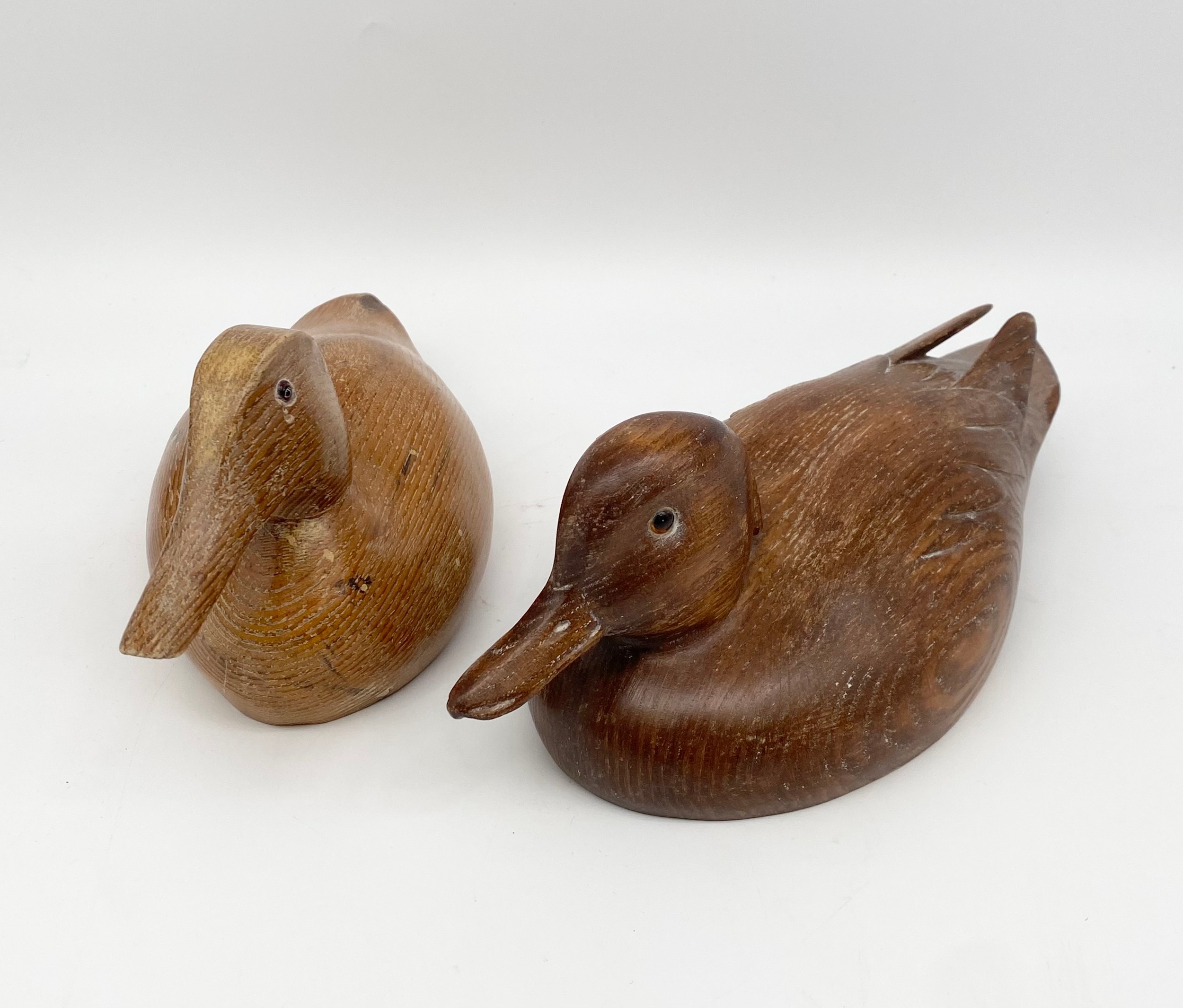 A vintage carved ash decoy duck titled 'Teal Drake' by Archie Thomson together with another