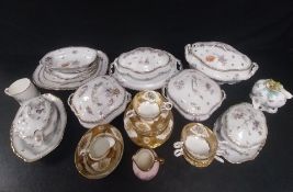 A 19th century hand painted porcelain part dinner service to include lidded tureens and platters etc