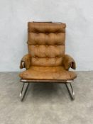 A 1970s Norwegian tan leather and chrome lounge chair with deep buttoned back and seat raised on