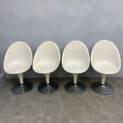 A set of four vintage Bombo dining chairs each with white composite moulded egg or bucket seat