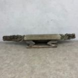 A 20th century African tribal hardwood ceremonial bench of abstract figural form with carved