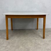 A mid-century kitchen or dining table with checked formica top raised on straight supports. H.76 W.