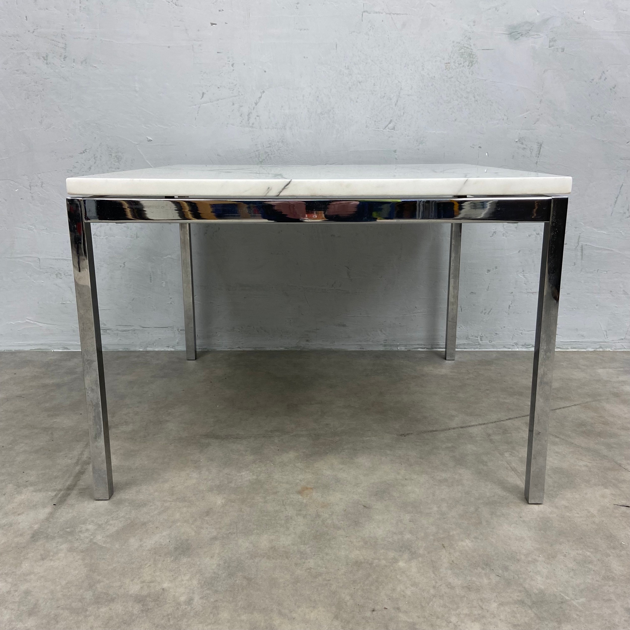 A mid to late 20th century low side or coffee table in the style of Florence Knoll with white marble