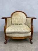 A 19th century walnut bergere armchair in the French Louis XV style having a shaped back and arms