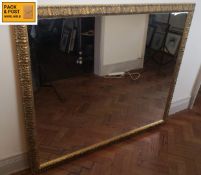 A large contemporary overmantel mirror in scrolling foliate gilt frame. 135x115cm. (Fitted with