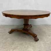 A 19th century Willian IV rosewood dining table with circular tilt-top and scalloped apron raised on