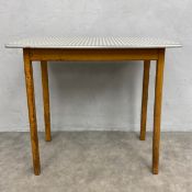 A mid-century kitchen side table with checked formica top raised on straight supports. H.76 W.81 D.