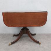 A Georgian mahogany and satinwood crossbanded drop flap dining table fitted with end drawer on swept