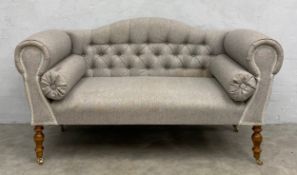 A small contemporary 19th century style window seat having a shaped deep-buttoned back and