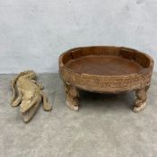A 19th century Indian carved teak low chakki table along with a carved crocodile. H.30 Diam.73cm. (