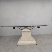 A 1980s vintage dining table with oval plate glass top on wrought iron and composite stone
