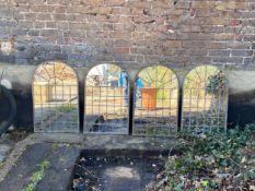 A set of four metal framed mirrors of domed architectural window form. 60x37cm.
